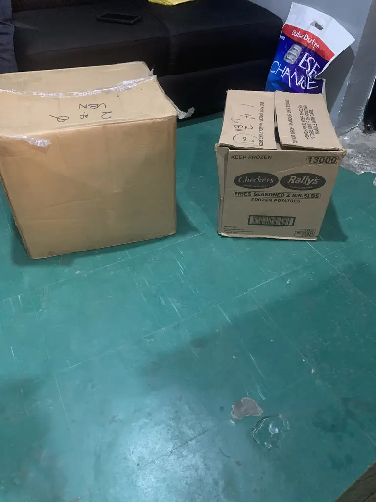 Standing Binatone Fan’ A bag, table and chair and laptop