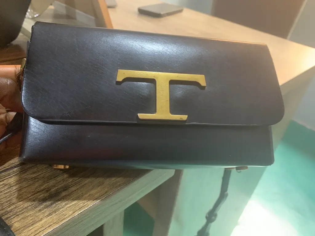 Standing Binatone Fan’ A bag, table and chair and laptop photo